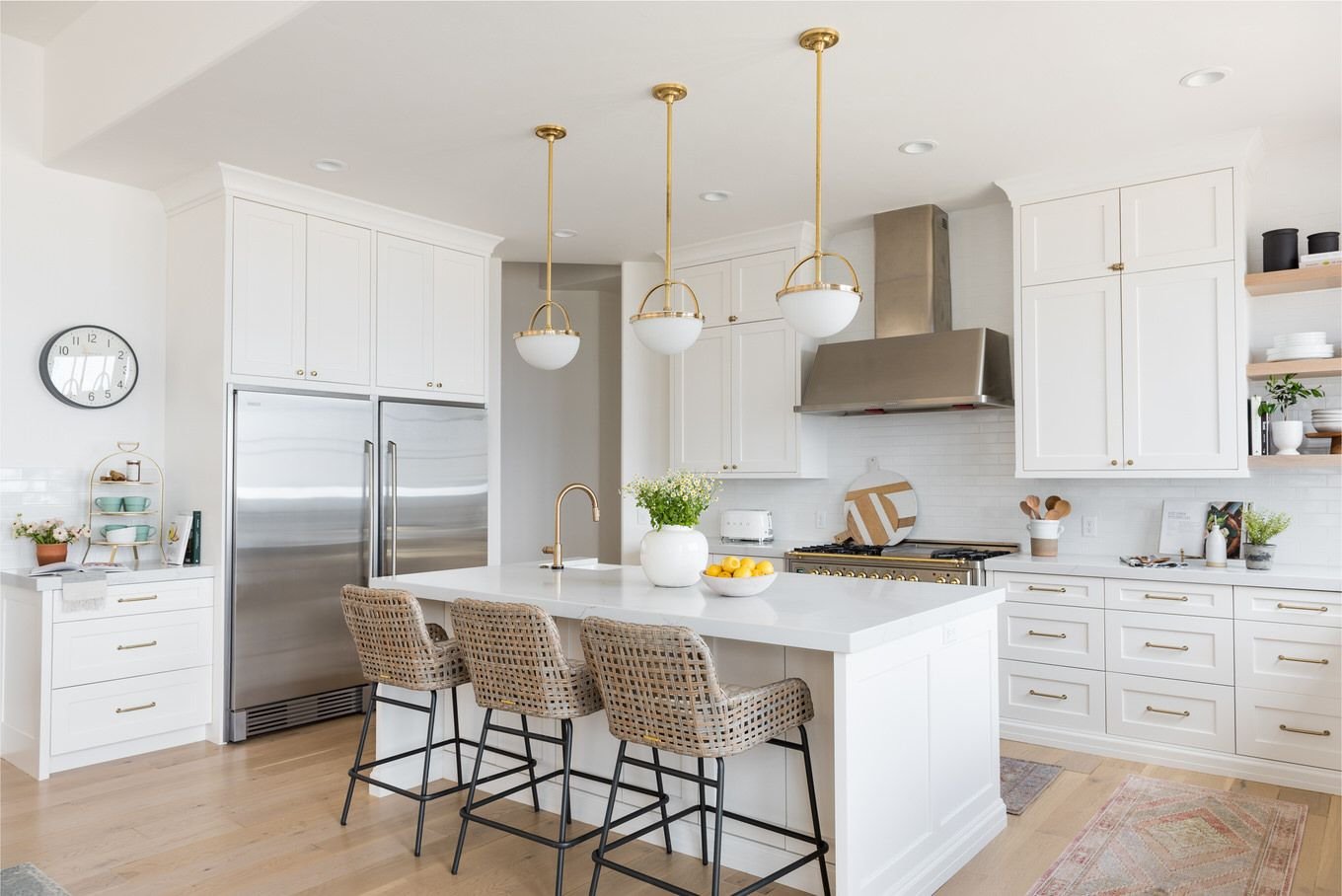 Renovated kitchen with a large island and brass pendants in a Carnegie Hill residence